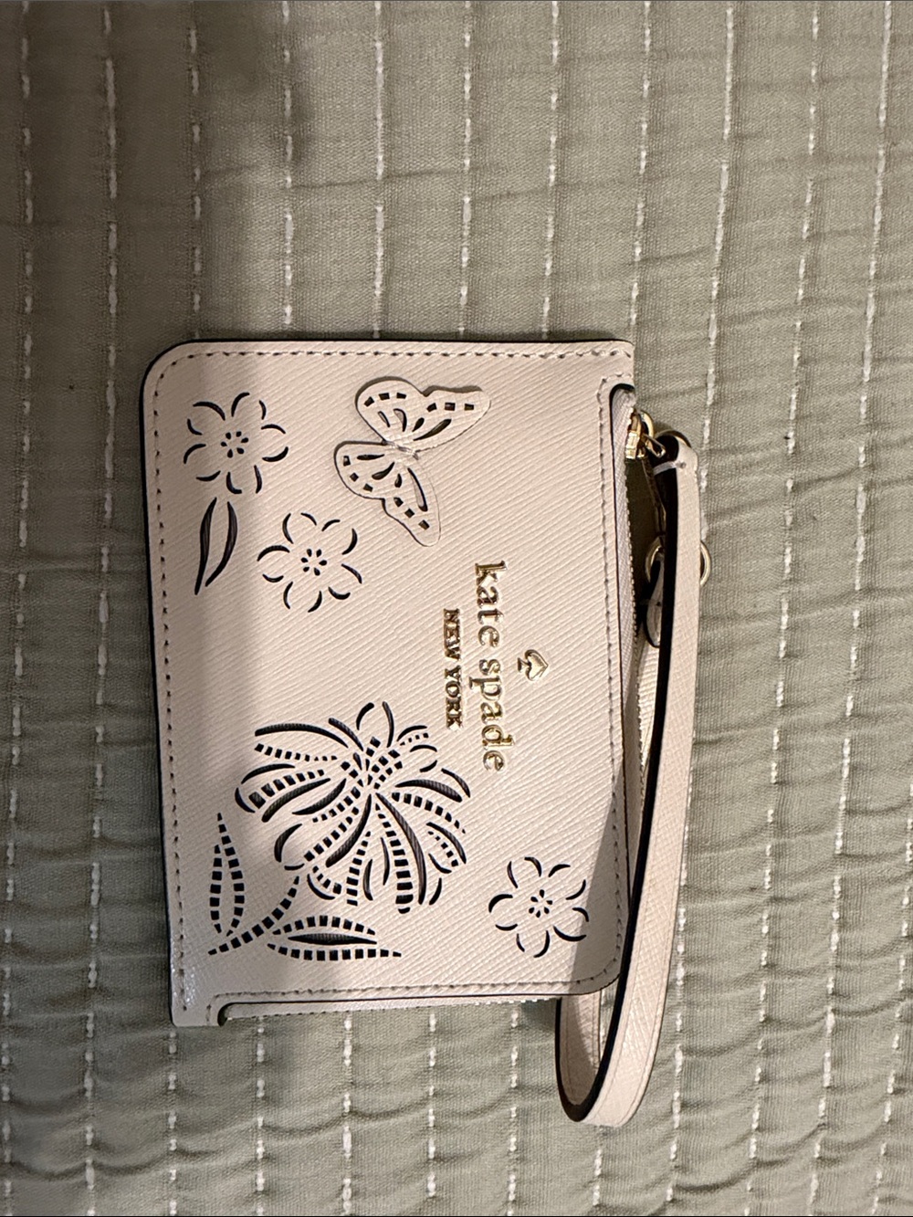 kate spade Pale Pink Floral & Butterfly Cutout Wristlet with Gold Logo